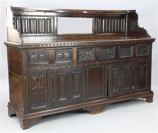 An antique Carolean style linenfold and foliate carved oak sideboard, W. 6ft 7in. D. 1ft 10in. 4ft 7in.